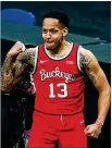  ?? MICHAEL CONROY / AP ?? Ohio State guard CJ Walker (13) celebrates a basket against Illinois during a championsh­ip game at the Big Ten Conference tournament.