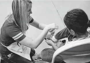  ?? [PHOTO PROVIDED] ?? A child tries on shoes provided by Citizens Caring for Children.