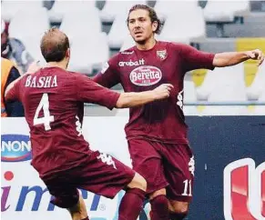  ??  ?? Hurray: Torino’s Alessio Cerci (right) celebrates after scoring a goal during Italian Serie A match against Fiorentina at Olympic stadium in Turin yesterday.
