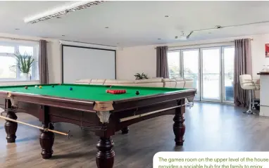  ??  ?? The games room on the upper level of the house provides a sociable hub for the family to enjoy