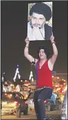  ?? (AFP) ?? Iraqi men celebrate during the general election in Baghdad on
May 14.