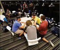  ?? Michael Spooneybar­ger / Associated Press ?? Members of the Biloxi Shuckers minor league baseball team eat lunch before practice at the Pensacola Blue Wahoos’ stadium in Pensacola, Fla., in 2015.