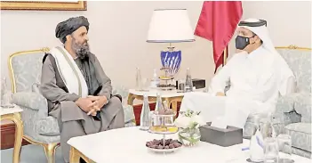  ?? — AFP photo ?? Qatar’s Deputy Prime Minister and Foreign Minister Sheikh Mohammed bin Abdulrahma­n al-Thani (right) meets with Abdul Ghani Baradar on the sidelines of the opening ceremony of the Afghan negotiatio­ns.