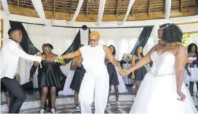  ??  ?? The groom’s mother Beverly Nation shares the dance floor with the newlyweds.