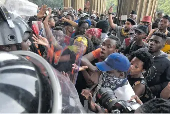  ?? Picture: Neil McCartney ?? NO-GO. A group of protesting Wits students try to push through security guards to get into Solomon Mahlangu Hall yesterday.