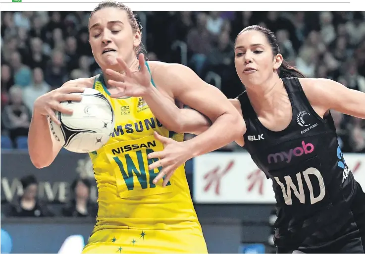  ??  ?? Sam Sinclair attempts to win the ball from Elizabeth Watson during a match in which the Silver Ferns struggled to impose themselves on Australia.