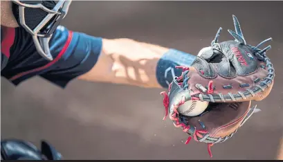  ?? BRACE HEMMELGARN/GETTY IMAGES ?? Like the sound of the ball off the bat, the impact of a pitch in the catcher’s mitt can have an impact on strike calls.