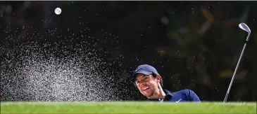  ?? MATTHEW LEWIS / GETTY IMAGES ?? Rory McIlroy plays out of a bunker Wednesday during the WGC HSBC Champions pro-am. “Just want to finish the year off strongly because I feel the year that I’ve had deserves a finish like that,” he said.