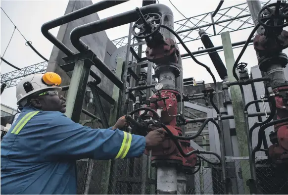  ?? AFP ?? A pipe being adjusted at the Shell-owned Afam VI power plant in Port Harcourt. Nigeria is Africa’s largest producer, accounting for about 2 million bpd of crude