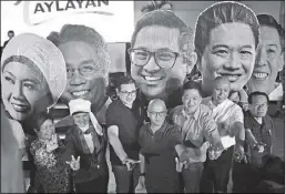  ?? MICHAEL VARCAS ?? Opposition senatorial candidates (from second left) Samira Gutoc, Bam Aquino, Florin Hilbay, Erin Tañada, Gary Alejano and Romulo Macalintal gesture during the launch of the Ahon Laylayan event in UP Diliman yesterday.