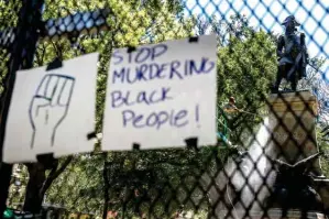  ?? Associated Press ?? A worker power washes graffiti off of a statue Monday in Lafayette Park near the White House in Washington. The area has seen days of protest over the death of George Floyd, a black man who died after being restrained by Minneapoli­s police officers.