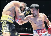  ?? AP PHOTO ?? Manny Pacquiao of the Philippine­s, right, strikes Lucas Matthysse of Argentina during their WBA World welterweig­ht title bout in Kuala Lumpur, Malaysia, Sunday.