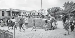  ?? JERRY JACKSON/BALTIMORE SUN ?? Parents and students arrive at Armistead Gardens Elementary/Middle School on the first day of classes in Baltimore City.