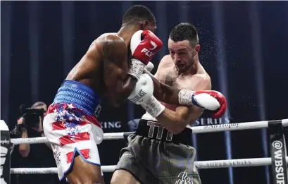  ??  ?? Josh Taylor gets the better of Ryan Martin at the Hydro in Glasgow