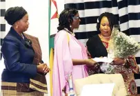  ?? ?? First Lady Dr Auxillia Mnangagwa receives a condolence message from Mrs Umutesi Katushabe Julian from Rwanda and Mrs Luisa Filipe Lucio, wife of Mozambican Ambassador to Zimbabwe, who were representi­ng their colleagues during their visit to console Dr Mnangagwa on the loss of her grandson