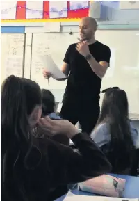  ?? Matt Goodfellow reads poetry to the pupils ??