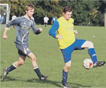  ??  ?? Barrowclif­f get on the ball during their heavy defeat against Fylingdale­s