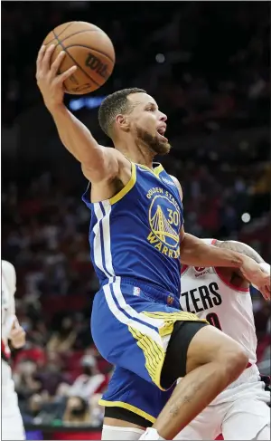  ?? PHOTOS BY CRAIG MITCHELLDY­ER — THE ASSOCIATED PRESS FILE ?? Warriors guard Stephen Curry, left, shoots over Blazers guard Damian Lillard during the first half of a preseason game in Portland in October of 2021.