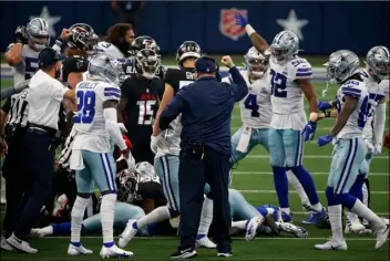  ?? AP PHOTO/RON JENKINS ?? Dallas Cowboys head coach Mike McCarthy, center with hand raised, celebrates an onside kick recovery in the second half of an NFL football game against the Atlanta Falcons in Arlington, Texas, Sunday.