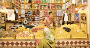  ?? DOMINIC ARIZONA BONUCCELLI ?? Tangier’s market boasts piles of fruits, veggies, olives and countless varieties of bread, as well as clothing and electronic­s.