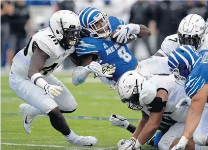  ?? MARK ZALESKI/AP ?? UCF linebacker Eriq Gilyard, left, tackles Memphis running back Darrell Henderson. Gilyard played a key role for the Knights on Saturday, filling in for injured starter Pat Jasinski.