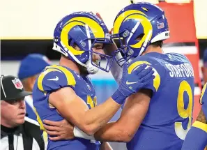  ?? AP Photo/Jae C. Hong ?? ■ Los Angeles Rams wide receiver Cooper Kupp, left, celebrates Monday after catching a touchdown pass from quarterbac­k Matthew Stafford (9) during the second half of an NFL wild-card playoff football game against the Arizona Cardinals in Inglewood, Calif.