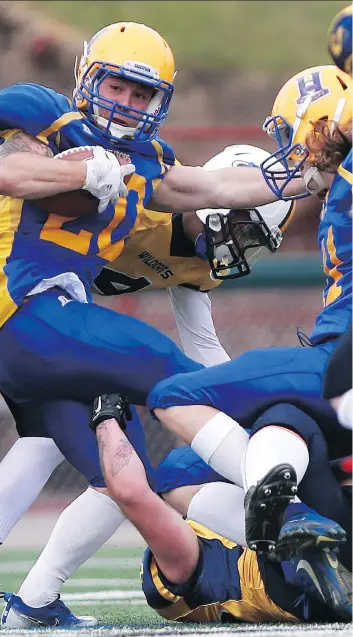  ?? MICHELLE BERG ?? Saskatoon Hilltops running back Adam Machart carries the ball Sunday during Canadian Junior Football League action against the Edmonton Wildcats at SMF Field. The Hilltops romped to a 51-0 victory.