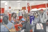  ?? Michael Liedtke The Associated Press ?? Customers wait in a long checkout line at a Target store Saturday in San Francisco.
