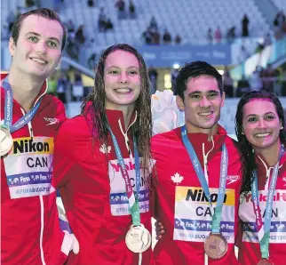  ?? FRANCOIS XAVIER MARIT/AFP/GETTY IMAGES ?? Canada’s Yuri Kisil, Penny Oleksiak, Richard Funk and Kylie Masse celebrate their bronze in the 4x100-metre mixed medley relay at the world championsh­ips Wednesday in Budapest.