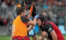  ??  ?? Matt Todd is tested for concussion during a Crusaders-Highlander­s match.