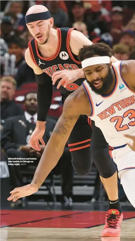  ?? GETTY ?? Mitchell Robinson and Knicks take tumble in Chicago on Friday night.