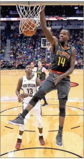  ?? Tyler Kaufman / AP ?? Atlanta forward Dewayne Dedmon dunks in front of New Orleans forward Cheick Diallo (13) in New Orleans.