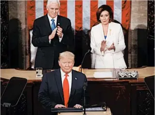 ?? MARK WILSON/GETTY ?? Vice President Mike Pence and House Speaker Nancy Pelosi applaud as President Trump steps to the lectern.