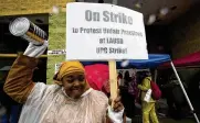  ?? ASSOCIATED PRESS ?? Teacher Sarah Harris joins fellow Los Angeles Unified School District staffers and members of the Local 99 of the Service Employees Internatio­nal Union members on the picket line Tuesday.