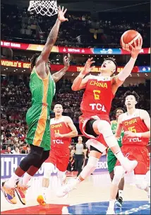  ??  ?? Guo Ailun of China goes up for a shot against Guy Landry Edi of Ivory Coast during their group phase basketball game in the FIBA Basketball
World Cup at the Cadillac Arena in Beijing on Aug 31, 2019. (AP)