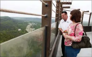  ?? PHOTOS BY CURT YOUNGBLOOD/TRI-LAKES EDITION ?? Michael Markwell of Louisville, Ky., and Elizabeth Hopkins of Cabot take in the view from atop the Hot Springs Mountain Tower.