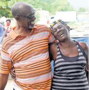  ?? PHOTOS BY KENYON HEMANS/PHOTOGRAPH­ER ?? Colin Fagan interacts with a constituen­t during a walk-through of a community in St Catherine South East on August 4.