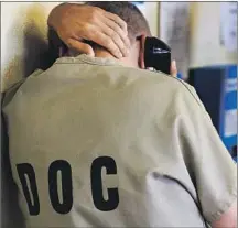  ?? Charles Rex Arbogast Associated Press By Laurence Darmiento ?? AN INMATE uses a phone at the Cook County Jail in Chicago in 2014. Securus is accused by activists of charging excessive rates.