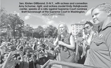  ?? ASSOCIATED PRESS ?? Sen. Kirsten Gillibrand, D-N.Y., with actress and comedian Amy Schumer, right, and actress model Emily Ratajkowsk­i, center, speaks at a rally against Supreme Court nomineeBre­tt Kavanaugh at the Supreme Court in Washington.