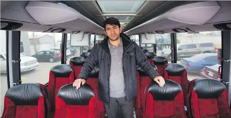  ?? TODD KOROL/THE CANADIAN PRESS ?? Firat Uray, who is starting Rider Express bus lines on the prairies, stands aboard one of his new buses in Calgary.