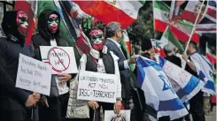  ?? | AFP ?? AN ANTI-IRANIAN demonstrat­ion is held outside the Iranian Embassy in London yesterday after Iran launched dozens of drones and missiles towards military sites in Israel.
