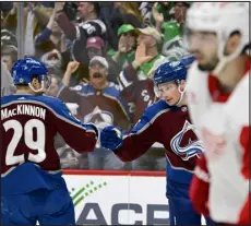  ?? ANDY CROSS — THE DENVER POST ?? Avalanche center Nathan Mackinnon greets teammate Cale Makar after Makar scored against the Detroit Red Wings at Ball Arena on March 6. Both players are in the running for major awards.