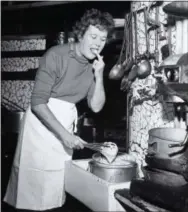  ?? PAUL CHILD — THE SCHLESINGE­R LIBRARY, RADCLIFFE INSTITUTE, HARVARD UNIVERSITY VIA AP ?? In this 1950s photo provided by Thames and Hudson, is Julia Child in the kitchen in France that is in the exhibit, “France is a Feast - The Photograph­ic Journey of Paul and Julia Child,” at the Napa Valley Museum in Yountville. The exhibit features...