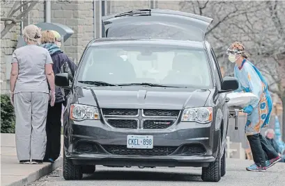  ?? FRANK GUNN THE CANADIAN PRESS ?? A body is loaded into a van at the Anson Place care centre in Hagersvill­e, Ont., on Wednesday. Well over 400 deaths have been reported amid outbreaks at 127 long-term care homes in the province.