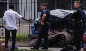  ?? Diego. Photograph: Mike Blake/Reuters ?? San Diego police officers enforcing the recently passed unsafe camping ordinance in San