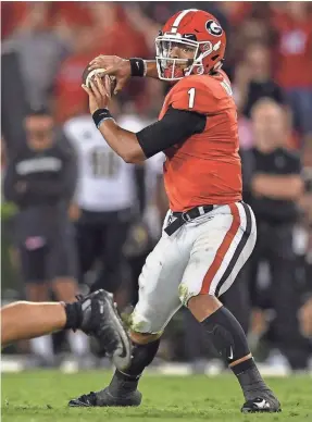  ?? DALE ZANINE/USA TODAY SPORTS ?? Georgia quarterbac­k Justin Fields had more rushing attempts (42) than passing attempts (39) but had 8 TDs, split evenly.