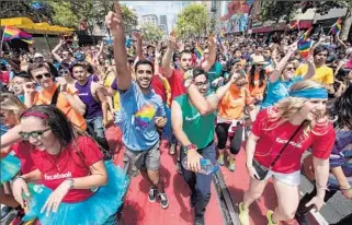  ??  ?? “TO BE I N THE PLACE that started it all, it gives me pride,” festival- goer Erin Harper said, referring to San Francisco’s status as a pioneer in gay rights. Above, Facebook employees.