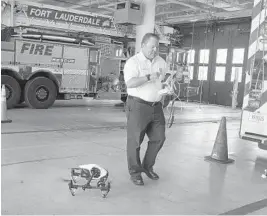  ?? CARLINE JEAN/STAFF PHOTOGRAPH­ER ?? Greg May, battalion commander for the Fort Lauderdale Fire Department, demonstrat­es some of the equipment used by firefighte­rs when responding to emergencie­s in high-rises.