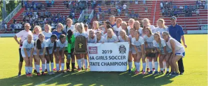  ?? TONY LENAHAN/THE Saline Courier ?? The Bryant Lady Hornets pose with their 6A state title trophy and banner after downing the Conway Lady Wampus Cats 2-1 in the championsh­ip Friday at Razorback Field in Fayettevil­le.