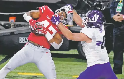  ?? DARRON CUMMINGS/ASSOCIATED PRESS FILE PHOTO ?? Ohio State linebacker Justin Hilliard, left, intercepts a pass against Northweste­rn on Dec. 19 in the Big Ten championsh­ip in Indianapol­is. Ohio State is vying for its first finals appearance since January 2015 when the Buckeyes won their last national title.